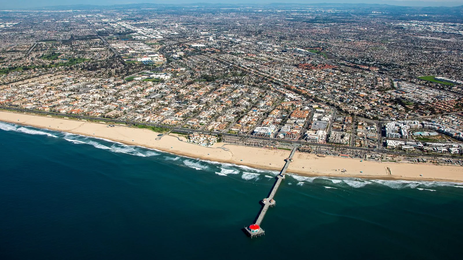 Aerial view of the Huntington Beach coastline and pier